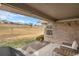 Covered patio with outdoor seating overlooking the green golf course at 7683 S Biloxi Way, Aurora, CO 80016