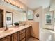 Bathroom featuring a double sink vanity and a separate area for the tub and toilet at 1649 Iris St, Broomfield, CO 80020