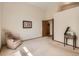 A bright bedroom showcasing a vaulted ceiling, a cozy chair, and soft natural light at 1649 Iris St, Broomfield, CO 80020
