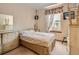 Cozy bedroom with neutral decor, a dresser, and a window for natural light at 1649 Iris St, Broomfield, CO 80020