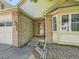 Inviting front entrance with brick accents, a screened door, and a well-maintained walkway at 1649 Iris St, Broomfield, CO 80020
