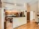 Open kitchen with wood cabinets, a breakfast bar, and seamlessly connected to a dining area at 1649 Iris St, Broomfield, CO 80020