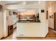 Cozy kitchen with wooden cabinets, granite countertops, and a pass-through to the living area at 1649 Iris St, Broomfield, CO 80020
