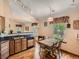 Eat-in kitchen with wood cabinets, granite countertops, and a view to the yard, creating a cozy atmosphere at 1649 Iris St, Broomfield, CO 80020