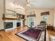 Open living room featuring a fireplace, built-in shelves, and large windows for natural light at 1649 Iris St, Broomfield, CO 80020