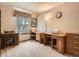 Home office area with two desks, a large window, and neutral decor at 1649 Iris St, Broomfield, CO 80020