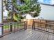 Backyard features a wood deck with railing, a beautiful tree, and a wood fence at 19897 E Brunswick Dr, Aurora, CO 80013