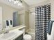 Bathroom features stylish shower curtain, sink, and a well-lit mirror at 19897 E Brunswick Dr, Aurora, CO 80013
