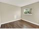 Neutral bedroom features hardwood floors and a window that provides ample natural light at 19897 E Brunswick Dr, Aurora, CO 80013