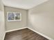 Simple bedroom with hardwood-style floors and a window for natural light at 19897 E Brunswick Dr, Aurora, CO 80013