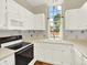 Bright kitchen with white cabinets, and a large window providing natural light at 19897 E Brunswick Dr, Aurora, CO 80013