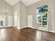 Spacious living area with hardwood floors, soaring ceilings, and large windows at 19897 E Brunswick Dr, Aurora, CO 80013