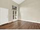 Bright, open living room with hardwood floors, large window, and tall ceilings at 19897 E Brunswick Dr, Aurora, CO 80013
