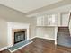 Inviting living room with fireplace, staircase, and hardwood-style floors at 19897 E Brunswick Dr, Aurora, CO 80013