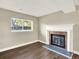 Cozy living room with a brick fireplace and a large window for natural light at 19897 E Brunswick Dr, Aurora, CO 80013
