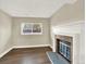 Comfortable living area with a fireplace and a window offering outdoor views at 19897 E Brunswick Dr, Aurora, CO 80013