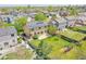 Aerial view of backyard featuring fence, patio, green lawn, and solar panels on roof at 11963 Dahlia Dr, Thornton, CO 80233