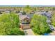 Aerial view of the home featuring mature trees, solar panels, and two car garage at 11963 Dahlia Dr, Thornton, CO 80233