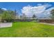 Spacious backyard with lush green lawn, privacy fence, and mature trees at 11963 Dahlia Dr, Thornton, CO 80233