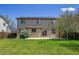 Home's backyard with green lawn, patio, privacy fence, and exterior of home at 11963 Dahlia Dr, Thornton, CO 80233