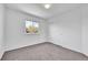 Bright bedroom featuring neutral carpet, a window, and closet with paneled sliding doors at 11963 Dahlia Dr, Thornton, CO 80233