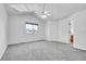 Serene bedroom with a vaulted ceiling, plush gray carpet, and a bright window for ample sunlight at 11963 Dahlia Dr, Thornton, CO 80233