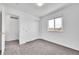 Bright bedroom with neutral carpet, closet with paneled sliding doors, and a sun-filled window at 11963 Dahlia Dr, Thornton, CO 80233