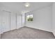 Clean bedroom with neutral carpet, ample closet space, and natural lighting at 11963 Dahlia Dr, Thornton, CO 80233