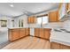 Bright kitchen featuring light wood cabinets, sleek countertops, and modern appliances at 11963 Dahlia Dr, Thornton, CO 80233