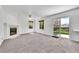 Inviting living room with fireplace, neutral carpet, and sliding glass doors at 11963 Dahlia Dr, Thornton, CO 80233