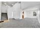 Bright living room featuring plush gray carpet, tall ceilings, and natural light from multiple windows at 11963 Dahlia Dr, Thornton, CO 80233