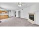 Open-concept living space with a cozy fireplace and seamless flow to the kitchen at 11963 Dahlia Dr, Thornton, CO 80233