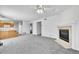 Open living area with fireplace, carpet, and access to the kitchen, ideal for modern living at 11963 Dahlia Dr, Thornton, CO 80233