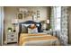Stylishly decorated bedroom with neutral walls, pops of gold, and chic furnishings at 3867 Freestone Pt, Castle Rock, CO 80108