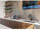 Elegant coffee bar featuring modern fixtures, floating shelves, and a flat-screen TV for convenience at 3867 Freestone Pt, Castle Rock, CO 80108