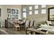 Dining room with large windows, modern chandelier and seating for six at 3867 Freestone Pt, Castle Rock, CO 80108