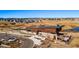 Exterior view of community clubhouse with green space in the background, parking and landscaping at 3867 Freestone Pt, Castle Rock, CO 80108