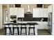 Beautiful kitchen with white cabinets, stainless steel appliances and a black backsplash at 3867 Freestone Pt, Castle Rock, CO 80108
