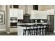 Beautiful kitchen with white cabinets, stainless steel appliances and a black backsplash at 3867 Freestone Pt, Castle Rock, CO 80108