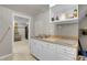 Small basement kitchen with white cabinets and a double sink at 1281 Myrtle St, Brighton, CO 80601