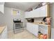 Bright basement kitchen featuring white cabinets and a microwave at 1281 Myrtle St, Brighton, CO 80601