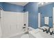 Clean bathroom with white tiled shower/tub combination, modern fixtures, and blue walls, offering a fresh aesthetic at 3228 W Girard Ave # C, Englewood, CO 80110