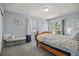 Bright bedroom featuring a wood-frame bed, ample natural light, and a cozy bench, creating a relaxing atmosphere at 3228 W Girard Ave # C, Englewood, CO 80110