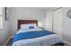 Simple bedroom design features a queen bed, closet with sliding doors and neutral tones for a clean look at 3228 W Girard Ave # C, Englewood, CO 80110