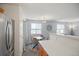 Open dining area featuring a modern table set and view-filled windows, seamlessly connected to the kitchen and living space at 3228 W Girard Ave # C, Englewood, CO 80110