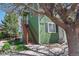 Green exterior of house with wooden stairs with a beautiful tree in the front at 3228 W Girard Ave # C, Englewood, CO 80110