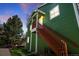 Green exterior of house with wooden stairs and a well maintained lawn at 3228 W Girard Ave # C, Englewood, CO 80110