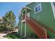 Green exterior of house with wooden stairs and a well maintained lawn at 3228 W Girard Ave # C, Englewood, CO 80110