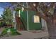 Green exterior of house with wooden stairs with a beautiful tree in the front at 3228 W Girard Ave # C, Englewood, CO 80110