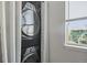 Stacked washer and dryer with a window view of exterior at 3228 W Girard Ave # C, Englewood, CO 80110